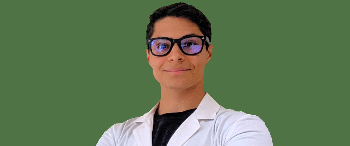 Tommaso Zanette dressed with a lab coat in a green landscape cinematic background