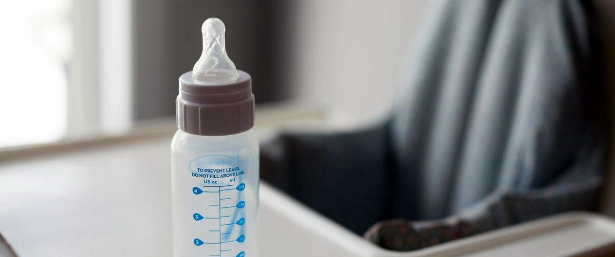 a baby bottle in a high chair