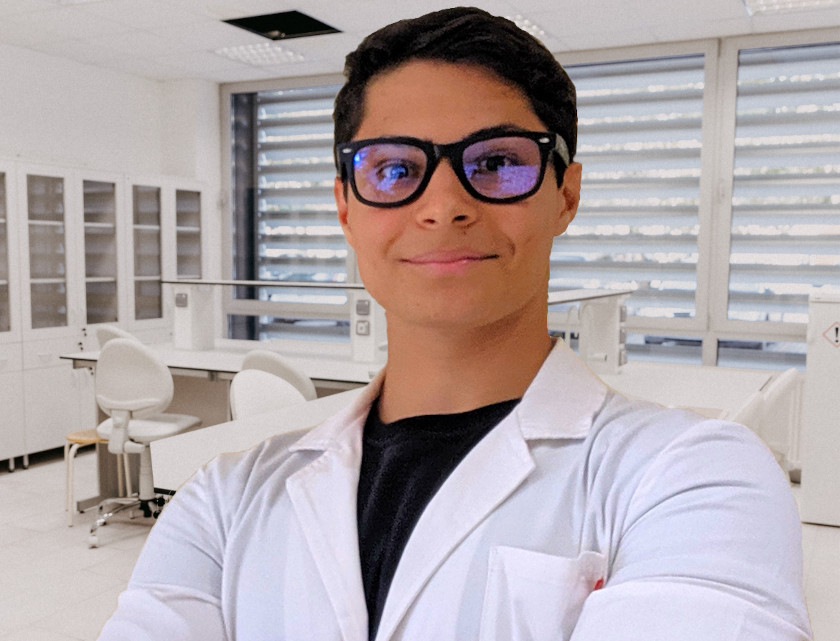 Portrait of Tommaso Zanette in a lab coat with goggles